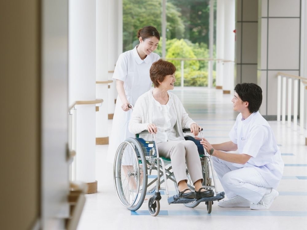 Illustrative caregiver greeting an older woman at home