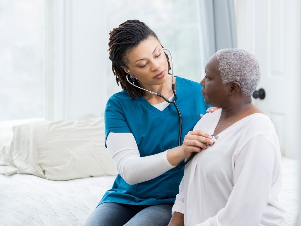 Illustrative care professional supporting an older man